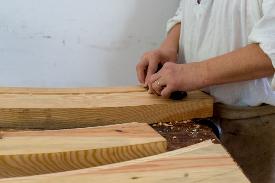 Master woodworker crafting handmade furniture in a traditional workshop